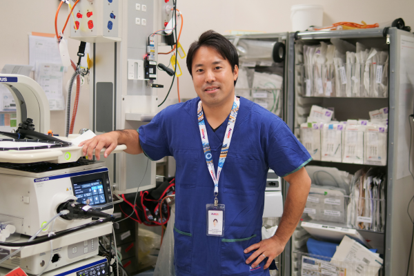 Dr Yuto Shimamura smiles at camera in the Endoscopy Unit at Austin Health